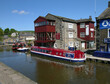 Red narrow boat moored on the Leeds Liverpool canal, Skipton, Yorkshire, UK