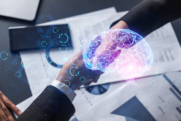 multiexposure of two businesspeople handshake and brain hologram drawing background. concept of data