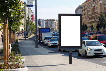 Billboard at the roadway on the sidewalk in the city.