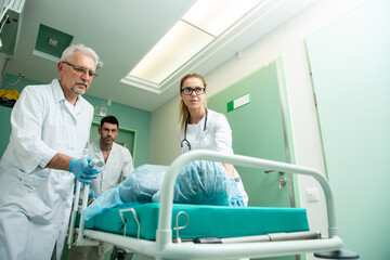 Team of Professional Surgeons and Nurses Suture Wound after Successful Surgery.