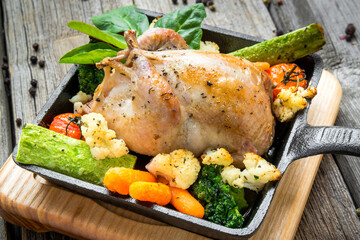 Wall Mural - Grilled pheasant with bacon and spices and vegetables