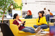 © Nikola Spasenoski - Three beautiful young female business colleagues having a chat in a modern office. Successfull startup team having a brainstorming meeting