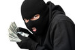 © Prostock-studio - Masked thief counting money isolated over white wall