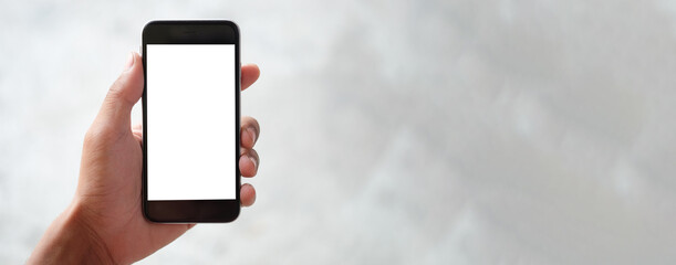 Cropped shot view of man hands holding smart phone with blank copy space screen for your text message or information content, female reading text message on cell telephone during in urban setting.