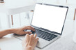 © panitan - computer mockup image blank screen.hand woman work using laptop with white background for advertising,contact business search information on desk at coffee shop.marketing and creative design