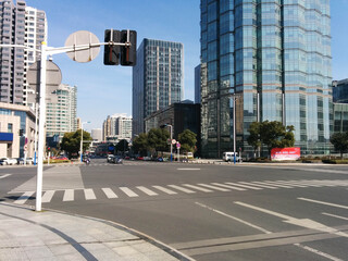 Changzhou, China - February 11, 2017: Crossing at the Changzhou Marriott Hotel in Changzhou China (Jiangsu province). The surrended buildings reflect in the glass facade of the hotel tower.