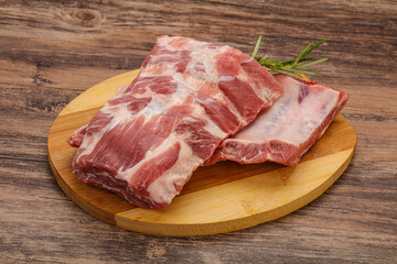 Raw pork ribs served rosemary