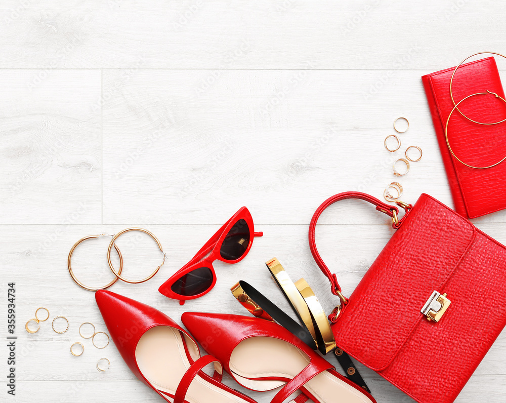 Set of female accessories on light wooden background