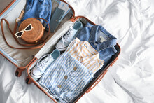 Open Packed Suitcase On Bed