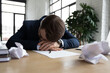 © fizkes - Tired male employee or worker feel fatigue exhaustion sleep or take nap at workplace, overwhelmed exhausted businessman fall asleep in office, preparing business report on deadline, overwork concept