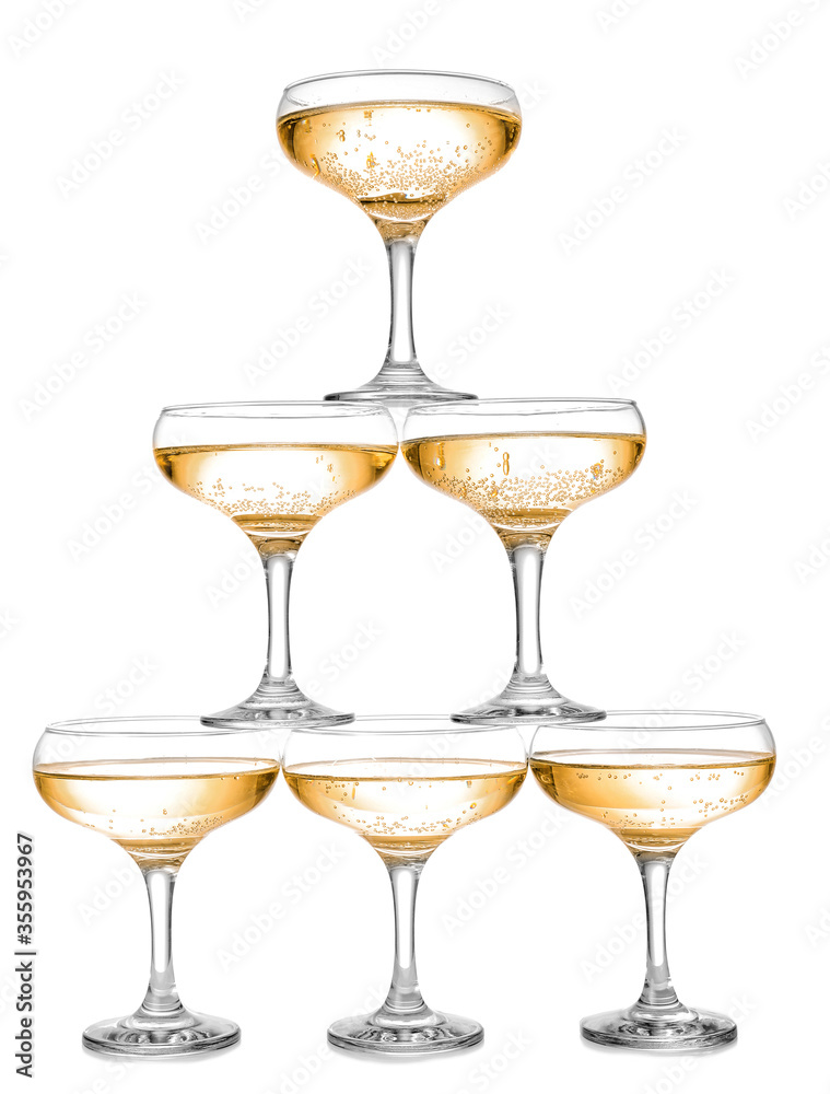 Tower made of glasses with champagne on white background