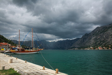 Old town settlement around lake, Kotor Bay, on background of blue sky and clouds, Montenegro, Europe