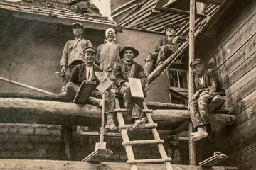 latvia - circa 1920s: photo of builders working on site. sitting on scaffolding. archive vintage bla