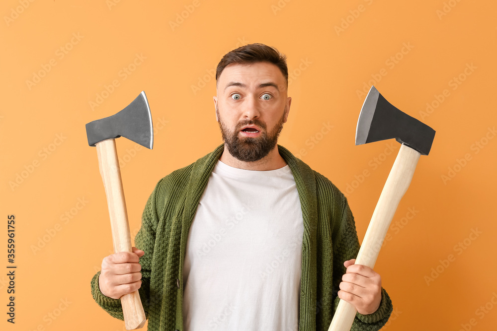 Handsome lumberjack on color background