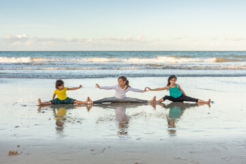 Children playing and exercising on the beach