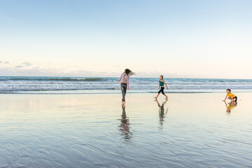 Children exercising on the beach juggling joy