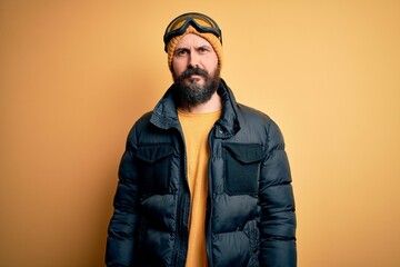 Poster - Handsome skier bald man with beard skiing wearing snow sportswear and ski goggles Relaxed with serious expression on face. Simple and natural looking at the camera.