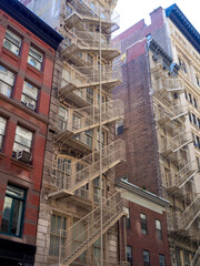 Canvas Print - Classic New York City midtown brick building facade with fire escapes