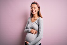 Young Beautiful Teenager Girl Pregnant Expecting Baby Over Isolated Pink Background Happy Face Smiling With Crossed Arms Looking At The Camera. Positive Person.