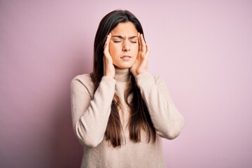 Poster - Young beautiful girl wearing casual turtleneck sweater standing over isolated pink background with hand on head for pain in head because stress. Suffering migraine.