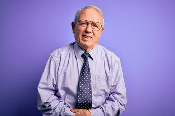 Sticker - Grey haired senior business man wearing glasses standing over purple isolated background with hand on stomach because indigestion, painful illness feeling unwell. Ache concept.