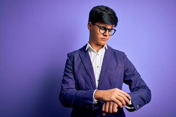 Poster - Young handsome business man wearing jacket and glasses over isolated purple background Checking the time on wrist watch, relaxed and confident