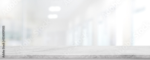 Cuadros en Lienzo Empty white marble stone table top and blur glass window interior lobby and hall way banner mock up abstract background - can used for display or montage your products
