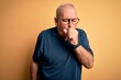 © Krakenimages.com - Middle age handsome hoary man wearing casual polo and glasses over yellow background feeling unwell and coughing as symptom for cold or bronchitis. Health care concept.
