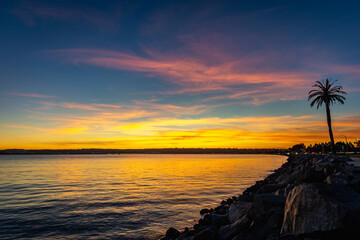 Wall Mural - Beautiful sunset with vibrant colors reflecting in the water of the Pacific Ocean in San Diego, California