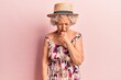 © Krakenimages.com - Senior grey-haired woman wearing summer hat feeling unwell and coughing as symptom for cold or bronchitis. health care concept.