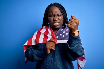 Poster - Young patriotic african american plus size woman with braids wearing united states flag annoyed and frustrated shouting with anger, crazy and yelling with raised hand, anger concept