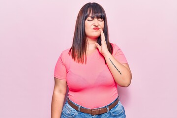 Poster - Young plus size woman wearing casual clothes touching mouth with hand with painful expression because of toothache or dental illness on teeth. dentist