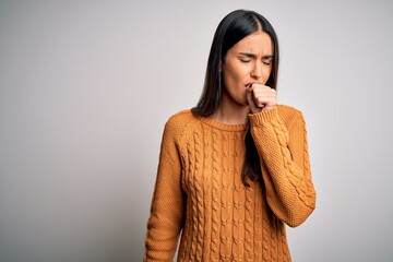 Wall Mural - Young beautiful brunette woman wearing casual sweater over isolated white background feeling unwell and coughing as symptom for cold or bronchitis. Health care concept.