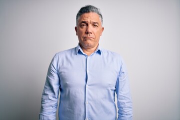 Poster - Middle age handsome grey-haired business man wearing elegant shirt over white background depressed and worry for distress, crying angry and afraid. Sad expression.