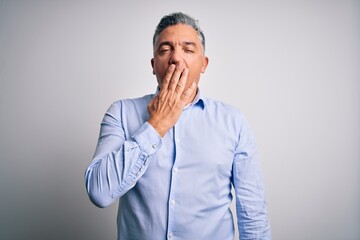 Poster - Middle age handsome grey-haired business man wearing elegant shirt over white background bored yawning tired covering mouth with hand. Restless and sleepiness.