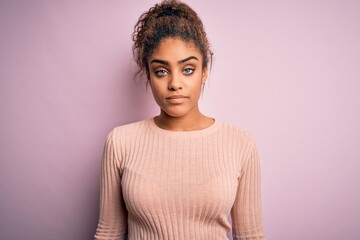 Poster - Young beautiful african american girl wearing casual sweater standing over pink background looking sleepy and tired, exhausted for fatigue and hangover, lazy eyes in the morning.