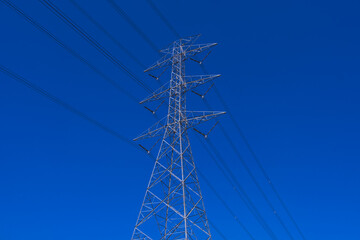 Electrical tower station wiring power with clearly blue sky background, High voltage station post