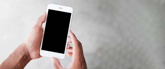 Mock up smartphone of hand holding black mobile phone with blank white screen.