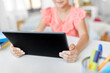 © Syda Productions - children, education and technology concept - close up of little student girl using tablet computer at home