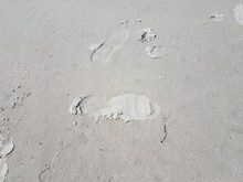 Foot Or Shoe Print Or Impression In Wet Sand
