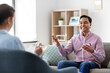 © Syda Productions - psychology, mental therapy and people concept - happy smiling young indian man patient and woman psychologist at psychotherapy session