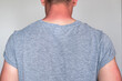 a man in a gray T-shirt with sunburned skin on his arms and neck. visible light and red sunburnt skin. UV protection, sunscreen, sunblock.