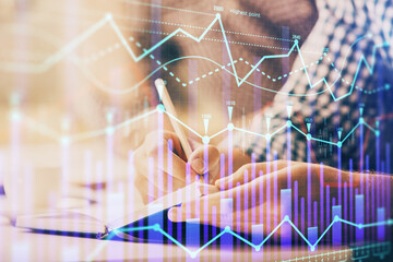 Multi exposure of two men planing investment with stock market forex chart.