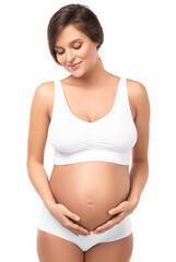 Wall Mural - Young and beautiful pregnant woman on white background