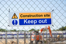 Keep Out Sign On The Fence Of A Construction Site - Hazardous Restricted Area.