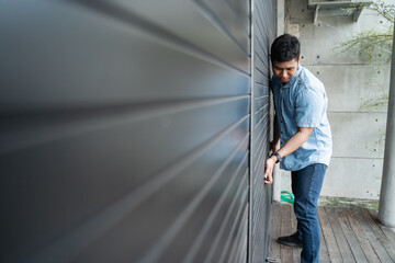 shop owner is lifting the door to open a shop