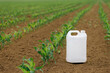 Corn pesticide canister in field, mock up image