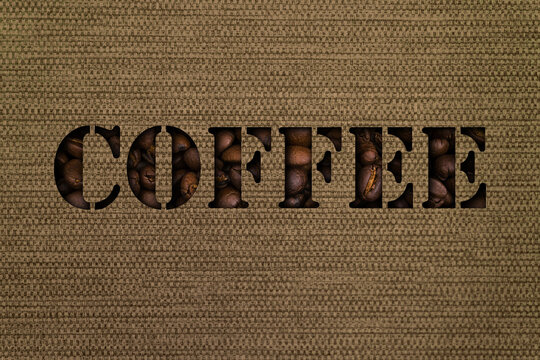 The text coffee made up of coffee beans on the background of canvas fabric