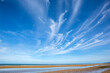 Beach view during the tide with cirrus clouds above.