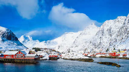 Fototapete - Traditional fishing village A on Lofoten Islands, Norway with red rorbu houses. With snow in winter